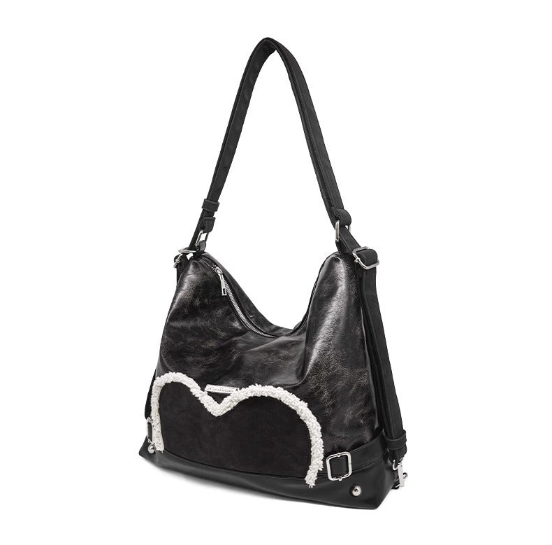 Stylish black tote backpack with heart embellishment - can be worn on one shoulder or as a backpack 3